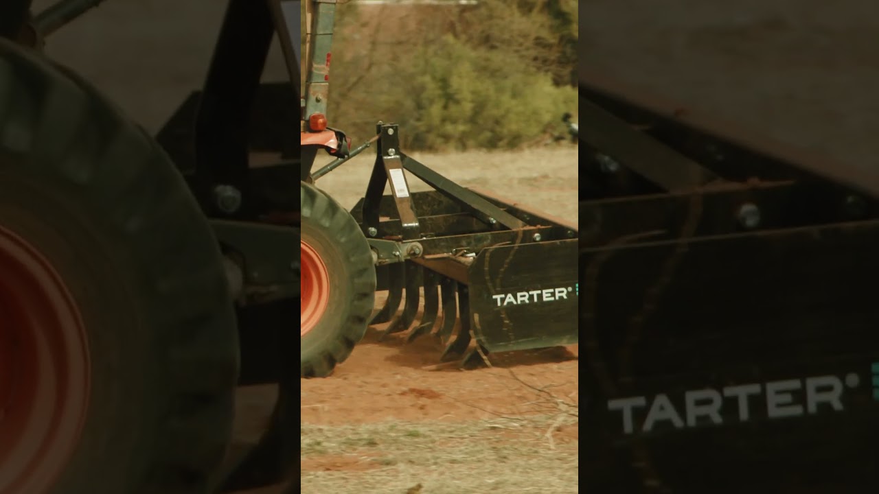 Vertical film preview of a tractor and Tarter implement working on bare ground.