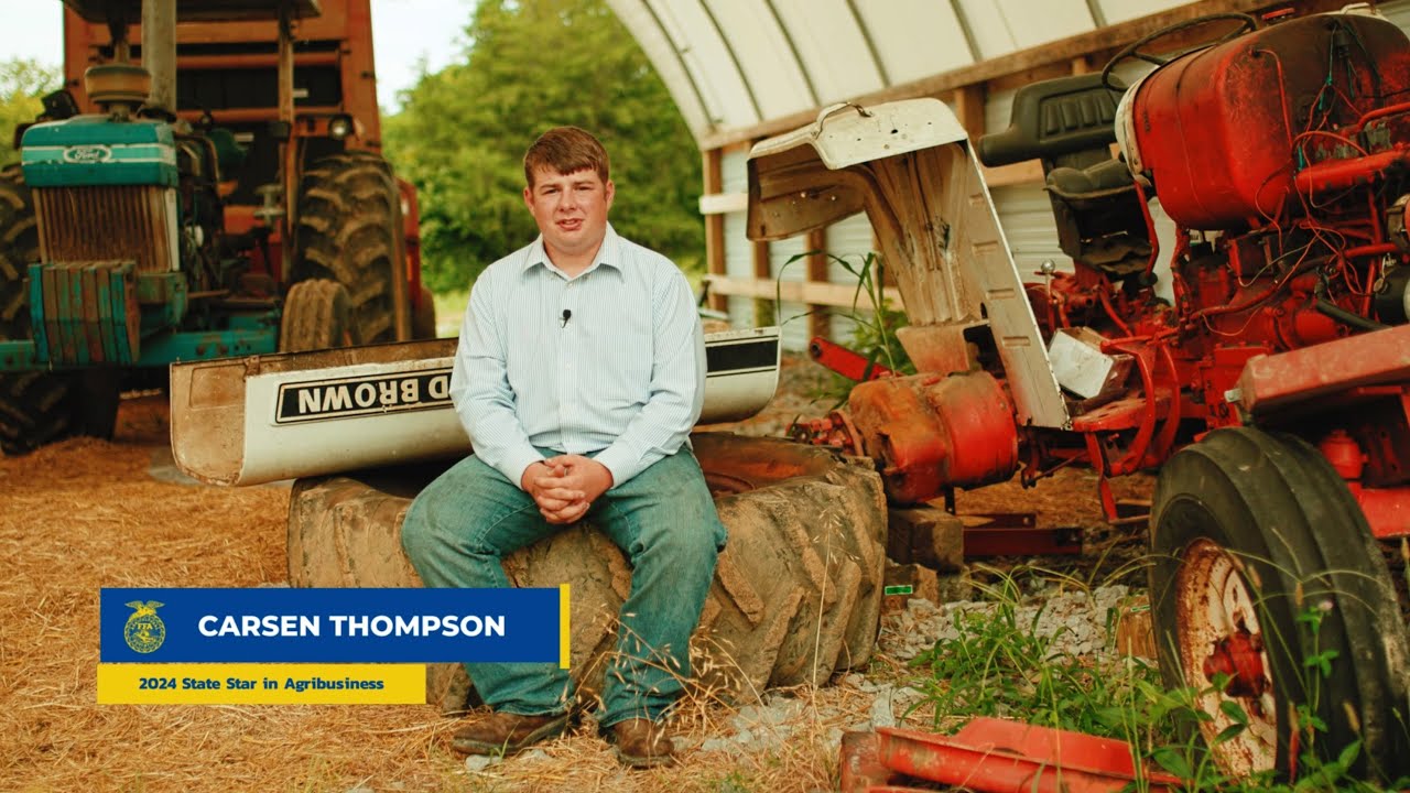 Interview preview of Carsen Thompson seated among agricultural equipment in a barn.